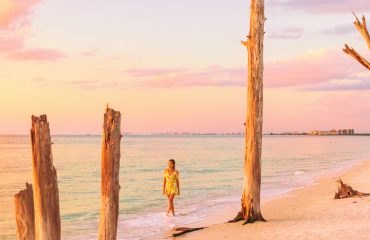Beach sunset paradise vacation dream tourist lifestyle woman walking on shore banner panoramic background. Woman relaxing in Lovers key, South west coast of Florida, USA travel.