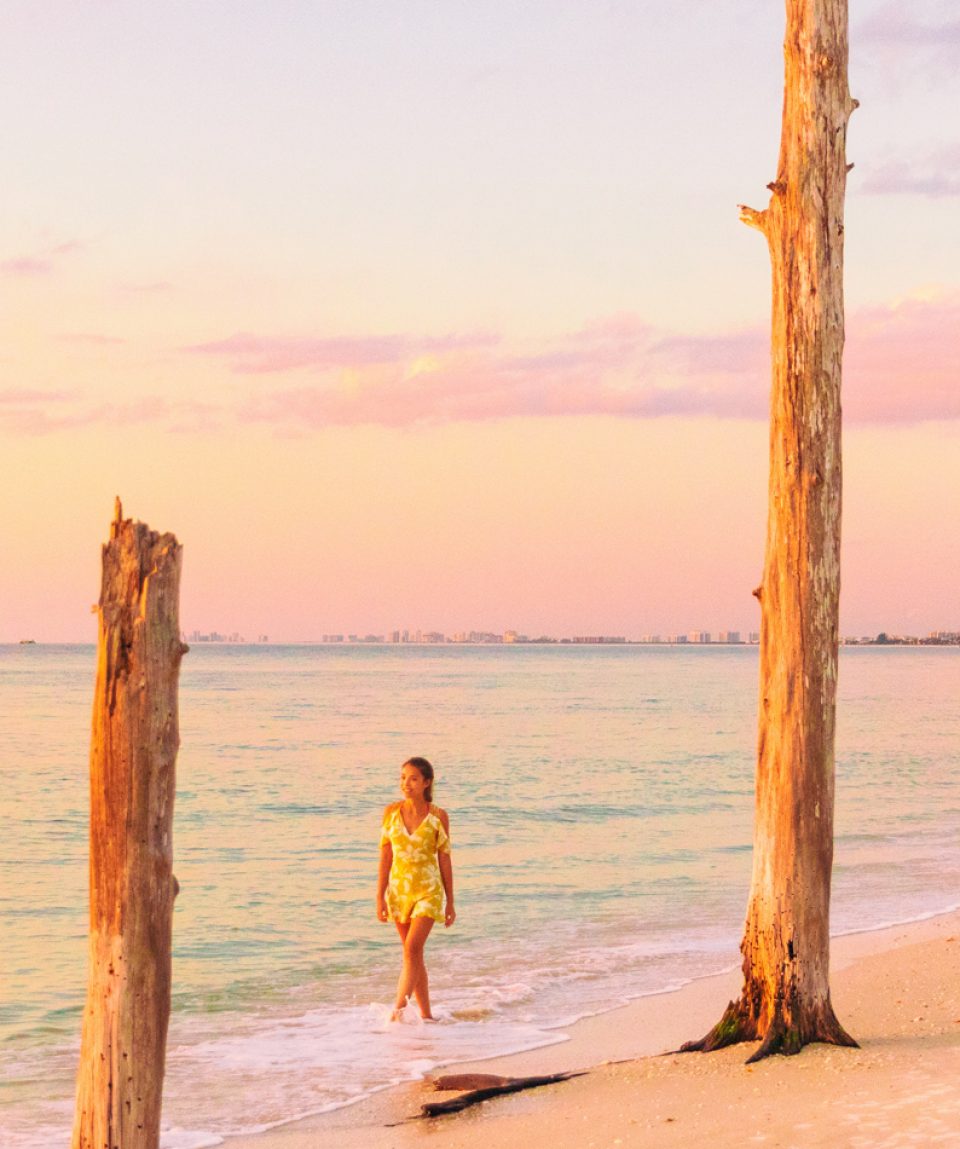 Beach sunset paradise vacation dream tourist lifestyle woman walking on shore banner panoramic background. Woman relaxing in Lovers key, South west coast of Florida, USA travel.
