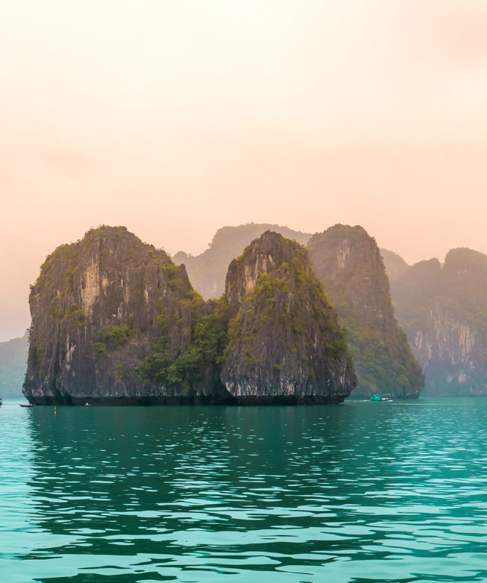 Beautiful Tourist cruise ship floating among limestone rocks at